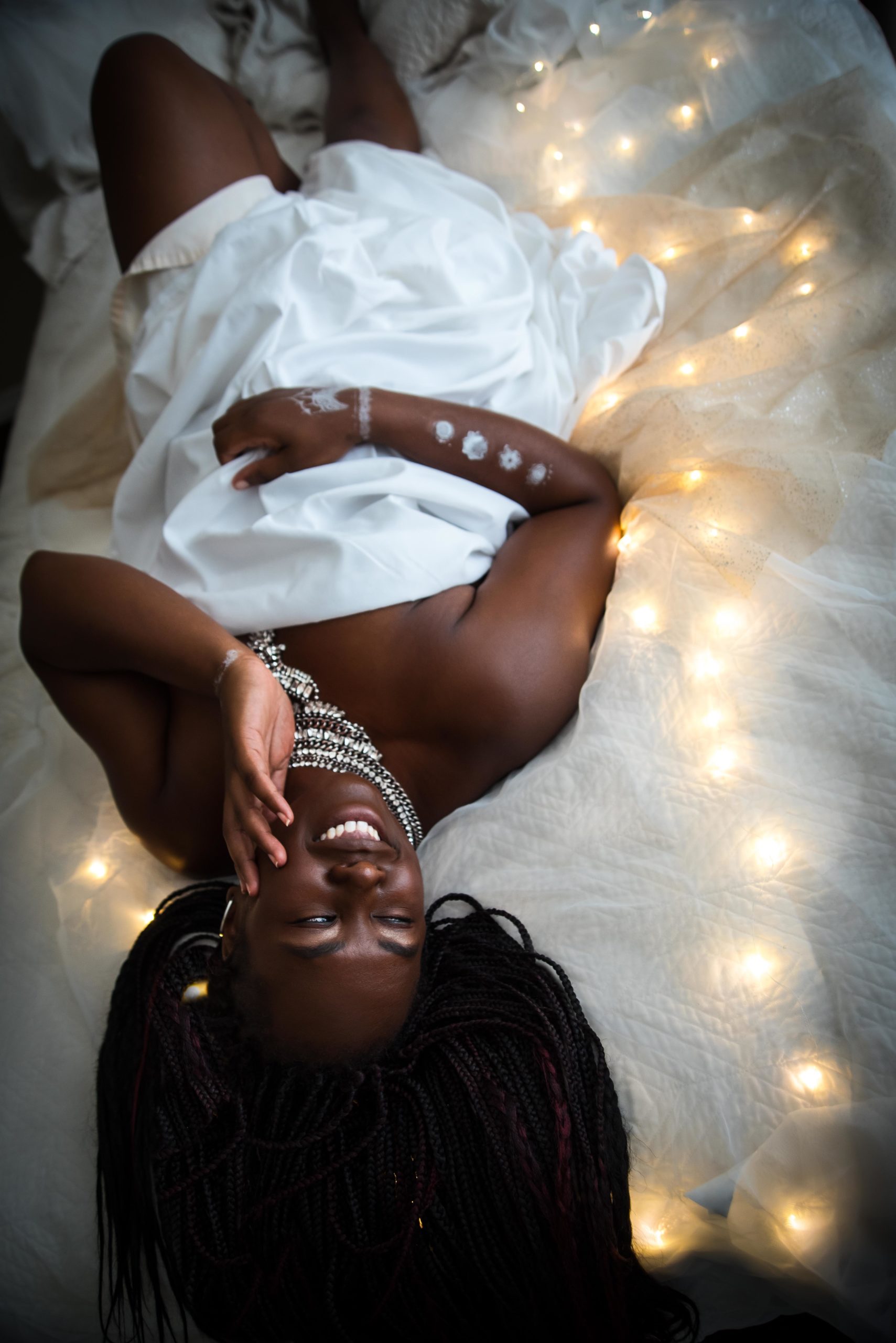 beautiful black women posing in bed on lights
